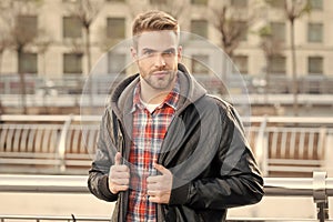 Handsome look. Handsome man on urban outdoors. Caucasian guy with unshaven handsome face and stylish hair. Style and