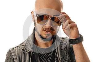 handsome macho man in sunglasses looking at the camera in sunglasses