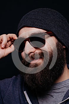 Handsome male big beard in glasses and hat