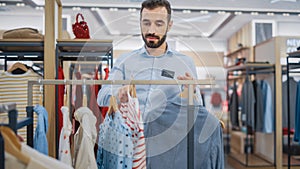 Handsome Male Clothing Store Assistant Works in Fashionable Shopping Mall. Professional Shop Sales