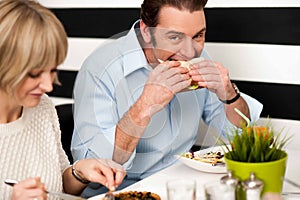 Handsome male enjoying his delicious sandwich