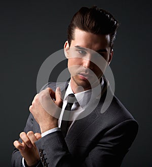 Handsome male fashion model posing in business suit