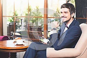 Handsome male has a french breakfast at cafe restaurant