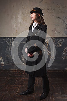 Handsome male in a hat-cylinder, Steam punk style. Retro man portrait over grunge background.