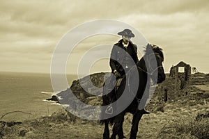 Handsome Male Horse Rider Regency 18th Century Poldark Costume with tin mine ruins and Atlantic ocean in background