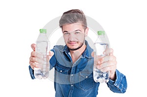 Handsome male model holding two bottles of cold water