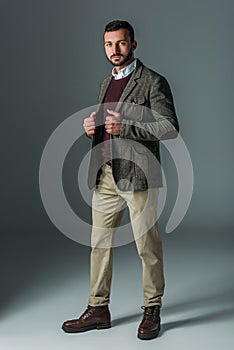 handsome male model posing in beige pants and tweed jacket