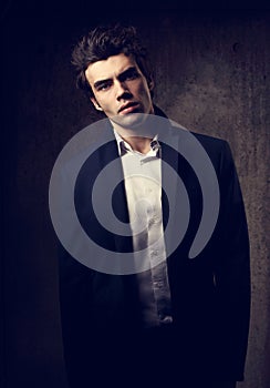 Handsome male model posing in fashion suit and white style shirt