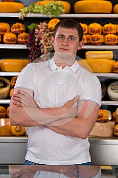 Handsome male owner of a cheese store