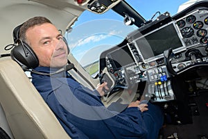 Handsome male pilot in cockpit