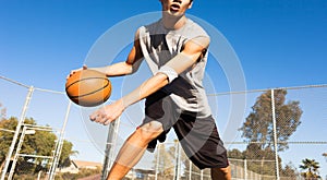 Handsome male playing basketball outdoor