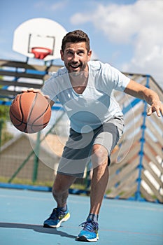 handsome male playing basketball outdoor