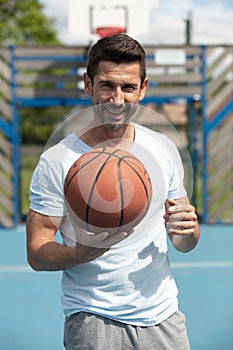 handsome male playing basketball outdoor