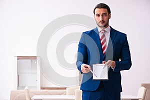 Handsome male realtor working indoors