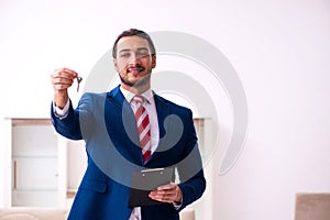 Handsome male realtor working indoors