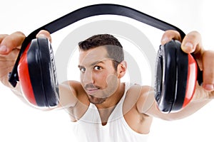 Handsome male showing headphone