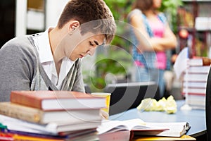 Handsome male student in a library