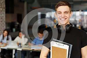 Handsome male student posing in campus library