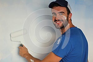 Handsome male about to paint a wall