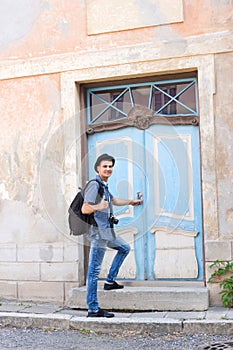 Handsome male tourist entering an old building