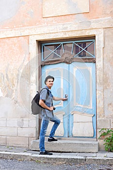 Handsome male tourist entering an old building