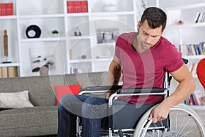 Handsome man in 40s sitting in wheelchair