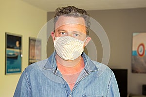 Handsome man adult wearing anti-virus bacteria pollution protective mask at home against coronavirus