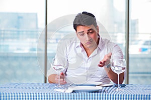 The handsome man alone in restaraunt on date