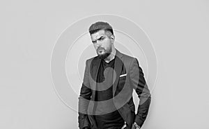 handsome man with beard and bristle on unshaven face wearing stylish formal casual business jacket, male beauty and