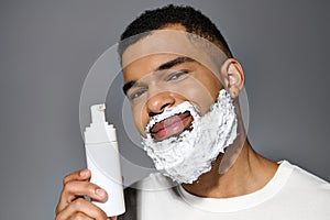 Handsome man with beard holds shaving