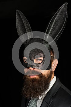 Handsome man with beard in playboy mask. Hipster with moustache. Handsome stylish bearded man. Serious man with beard in