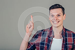 Handsome man with beard pointing in one direction on a blue background