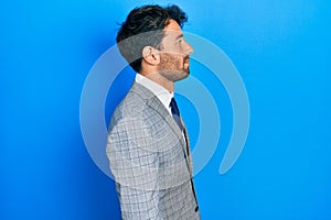 Handsome man with beard wearing business suit and tie looking to side, relax profile pose with natural face with confident smile