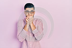 Handsome man with beard wearing casual shirt and glasses shocked covering mouth with hands for mistake