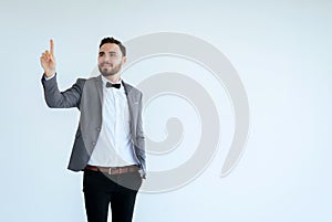 Handsome man with bearded in formal tuxedo and suit showing hand pointing something on white background,Copy space for text and di