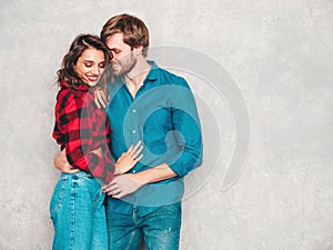 Handsome man and beautiful woman posing in studio