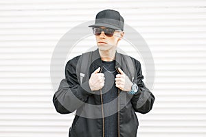 Handsome man with black glasses, a cap, a jacket with