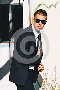 Handsome man in black suit and sunglasses. Secret agent, mafia, bodyguard concept