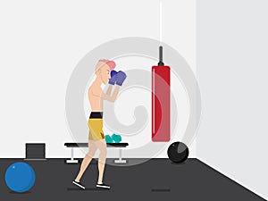 Handsome man in blue boxing gloves boxing in gym with red punching bag