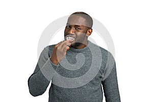 Handsome man brushing his teeth.