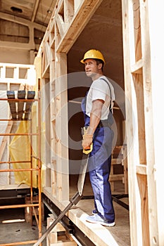 Handsome man builder standing in construction cabin