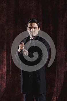 Handsome man in a business suit on a dark background