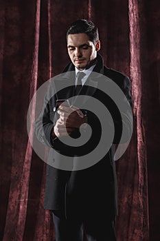 Handsome man in a business suit on a dark background