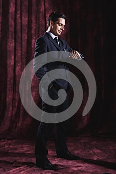 Handsome man in a business suit on a dark background