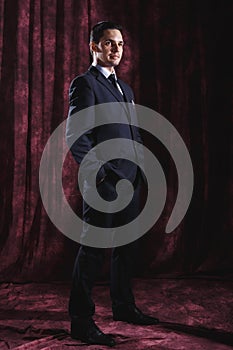 Handsome man in a business suit on a dark background