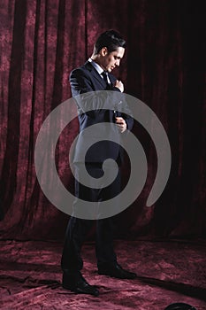 Handsome man in a business suit on a dark background