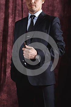 Handsome man in a business suit on a dark background