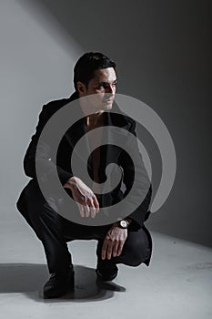 Handsome man in a business suit on a dark background