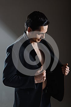 Handsome man in a business suit on a dark background