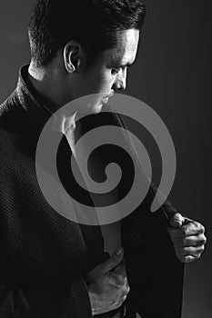 Handsome man in a business suit on a dark background